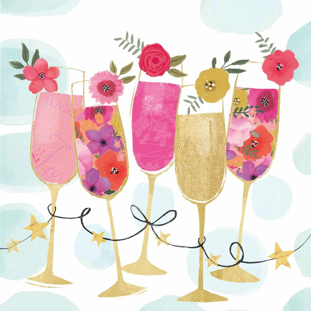 Champagne glasses filled with pink drinks and with flowers on rim