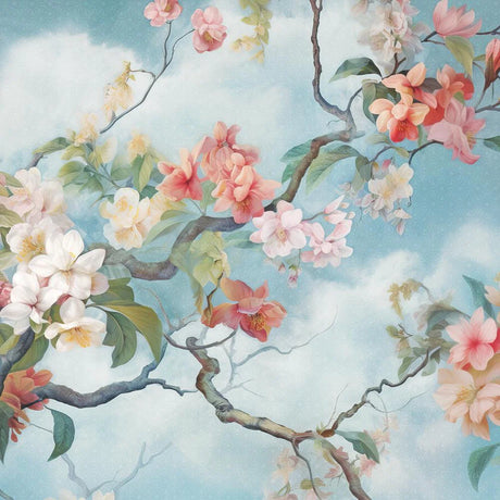 Delicate magnolia blossoms on branch against blue sky with clouds