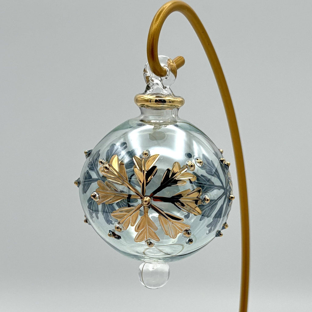 Decorative pale grey glass ball with gold leaf design  