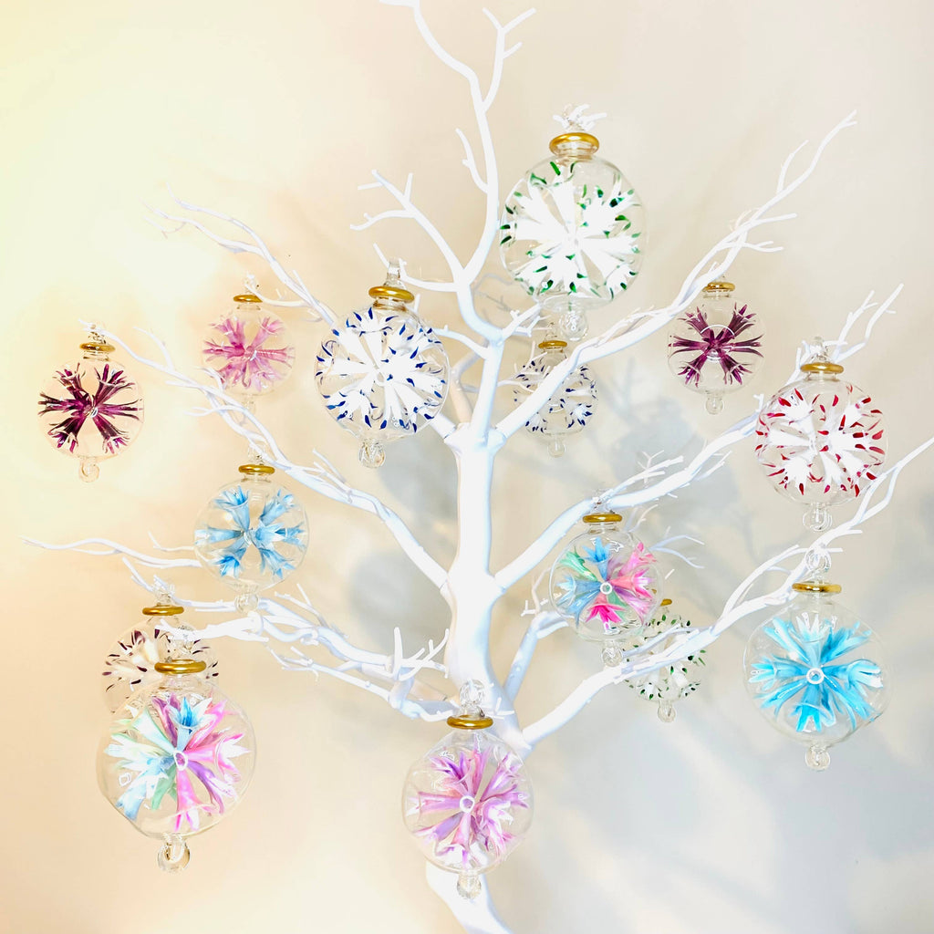 Decorative white Tree with colourful glass ornaments on a beige background