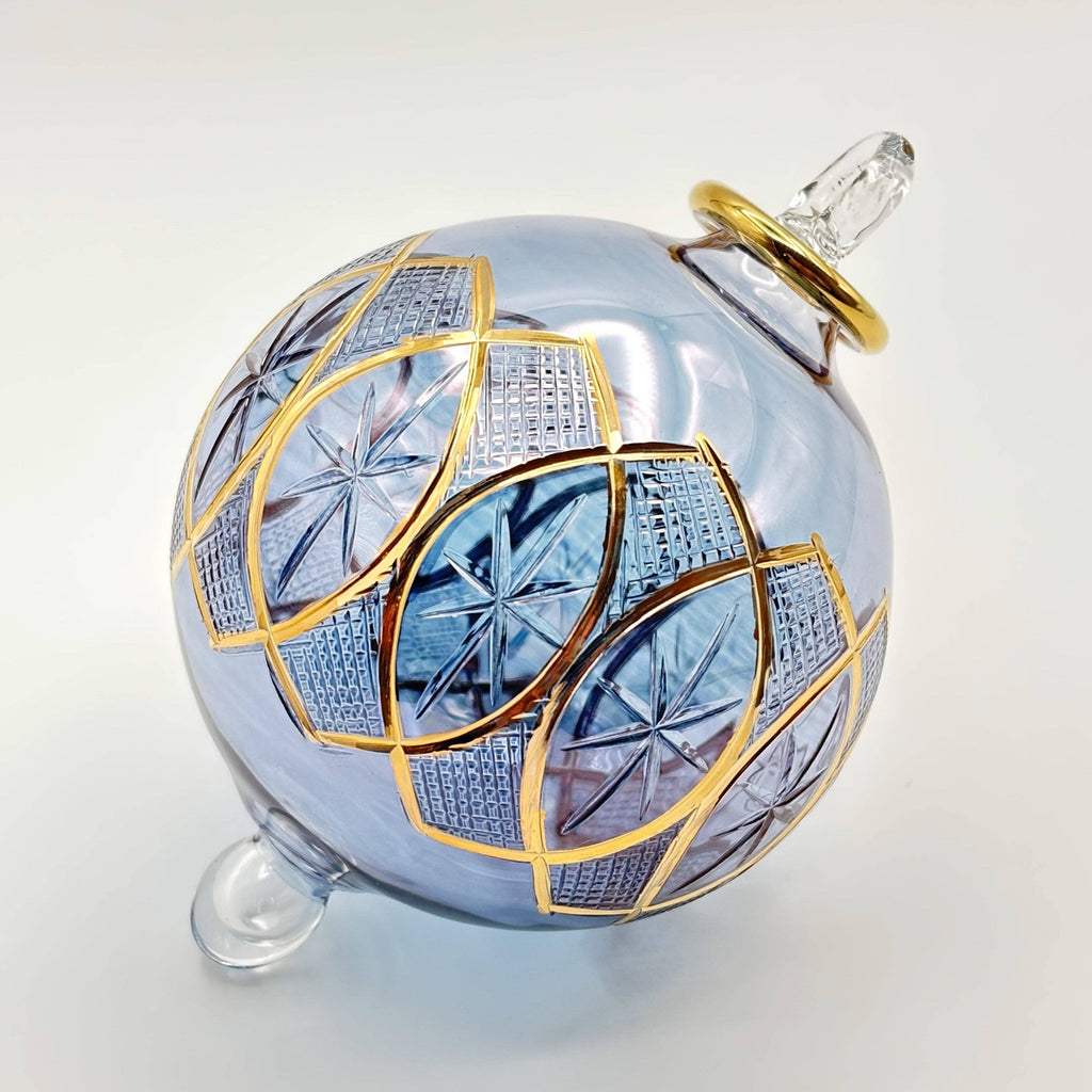 Decorative light blue glass ornament with gold and blue patterns
