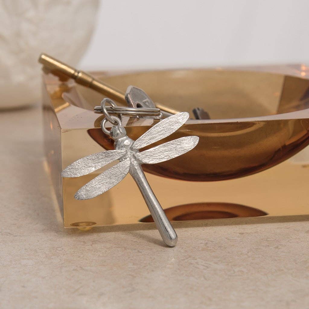 Pewter dragonfly keychain on an amber coloured glass key holder