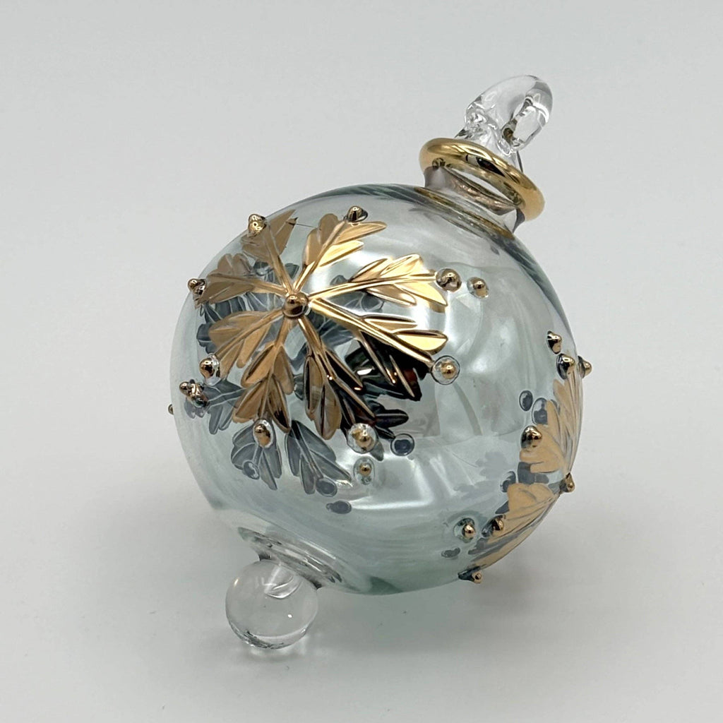 Decorative pale grey glass ball with gold leaf design  