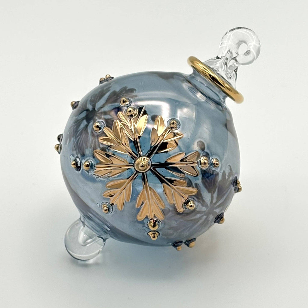 Decorative pale grey glass ball with gold leaf design  