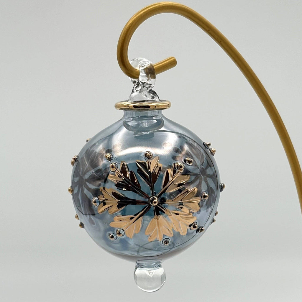 Decorative pale grey glass ball with gold leaf design  