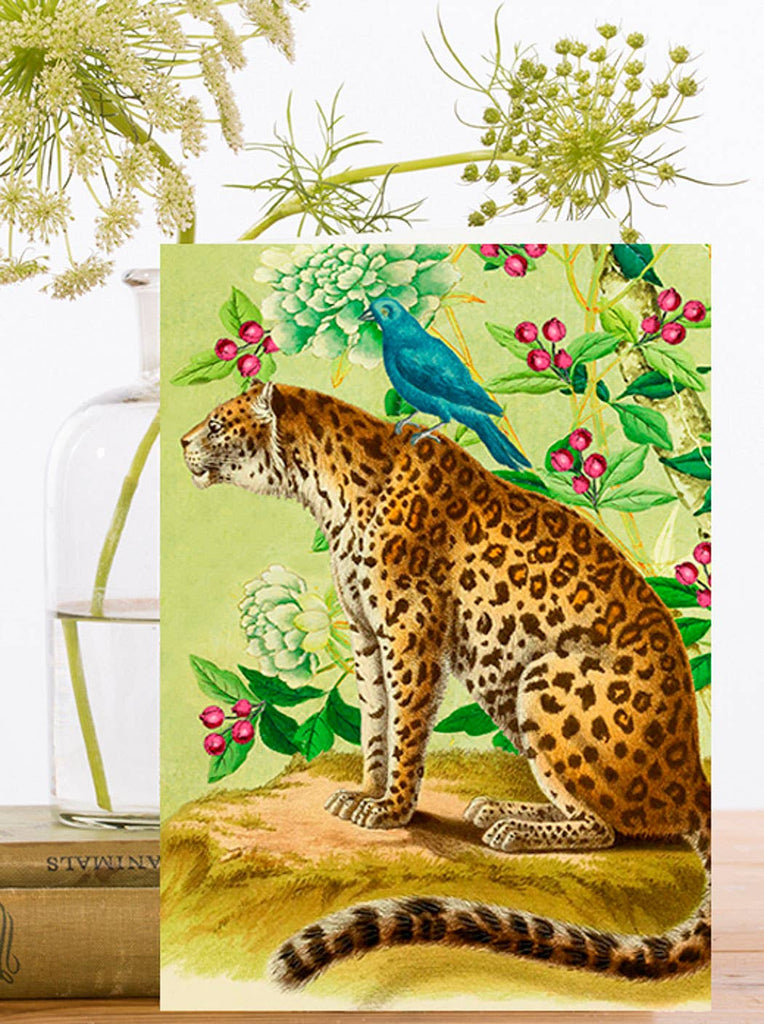 Greeting card with illustration of a leopard with a blue bird on a floral background