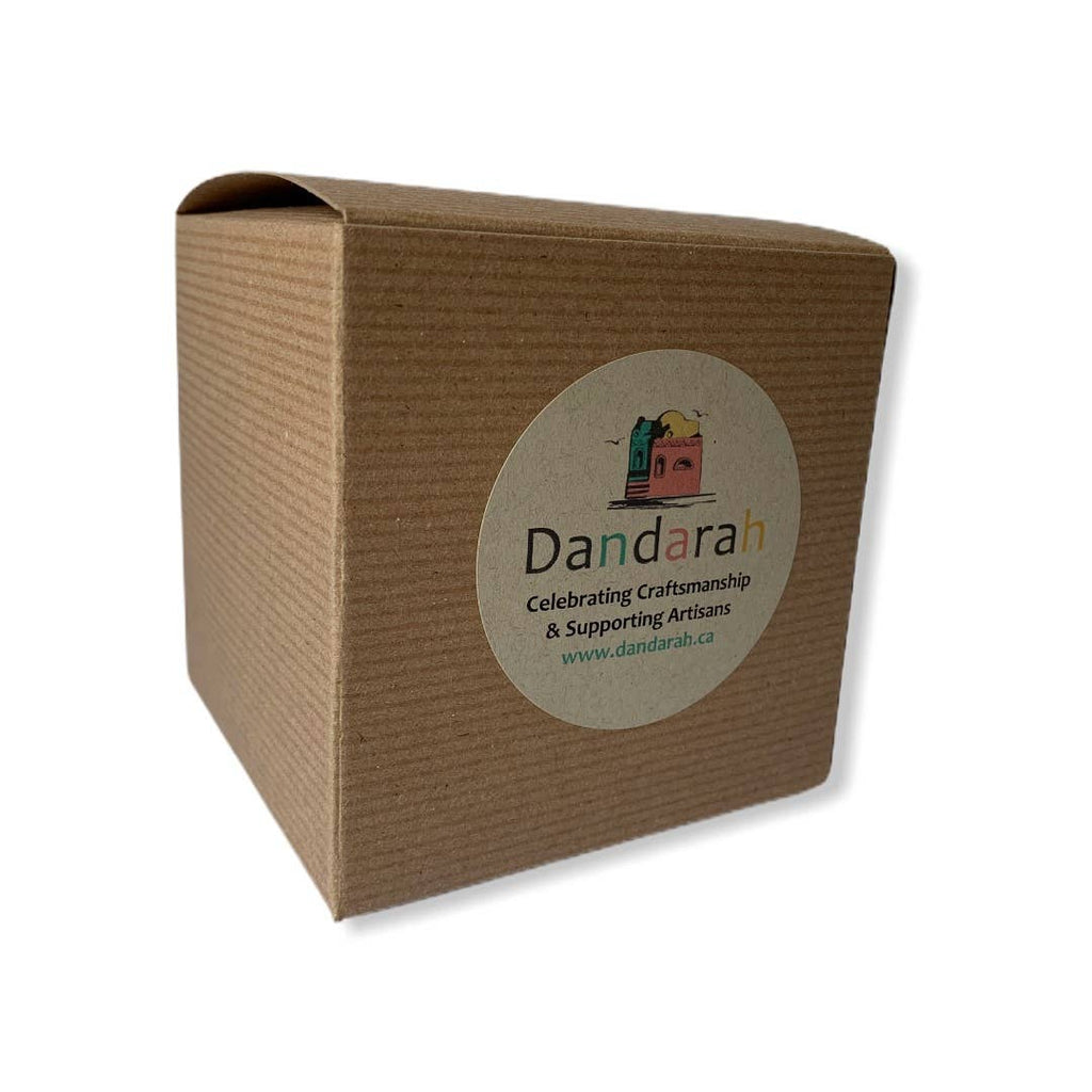 A brown cardboard box with a Dandarah label couild be used as a gift wrapping 