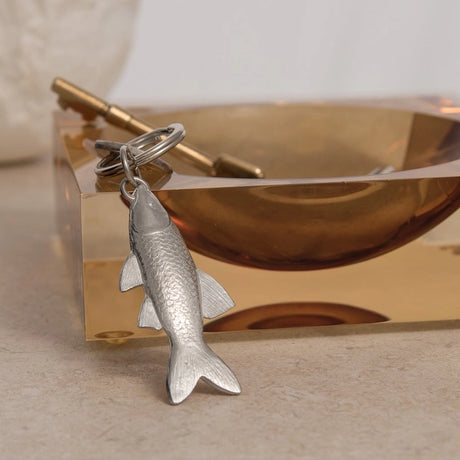 Silver fish-shaped key ring in a soft gold catchall