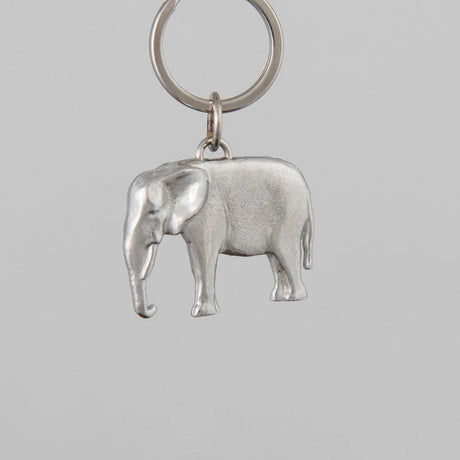 Silver elephant keychain on a gray background