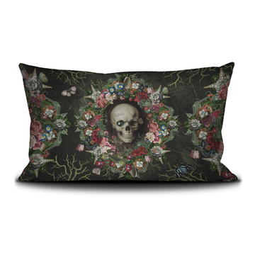 Decorative pillow with a skull and floral design on a black background