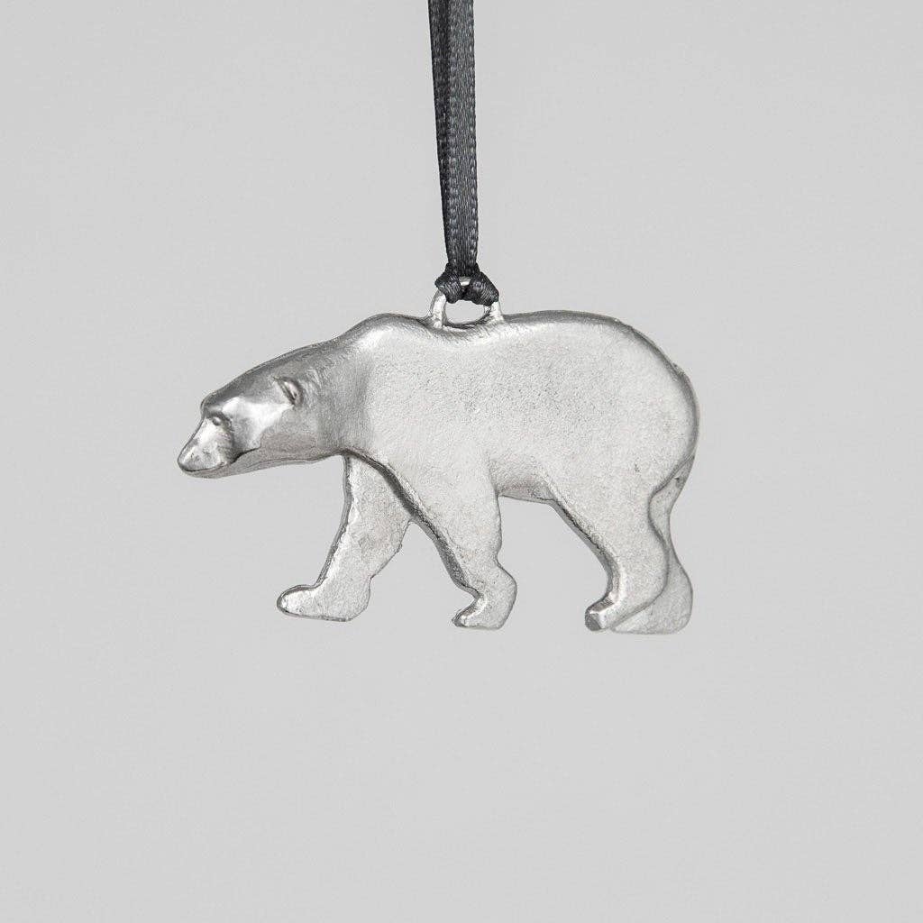 Pewter polar bear ornament on a gray background