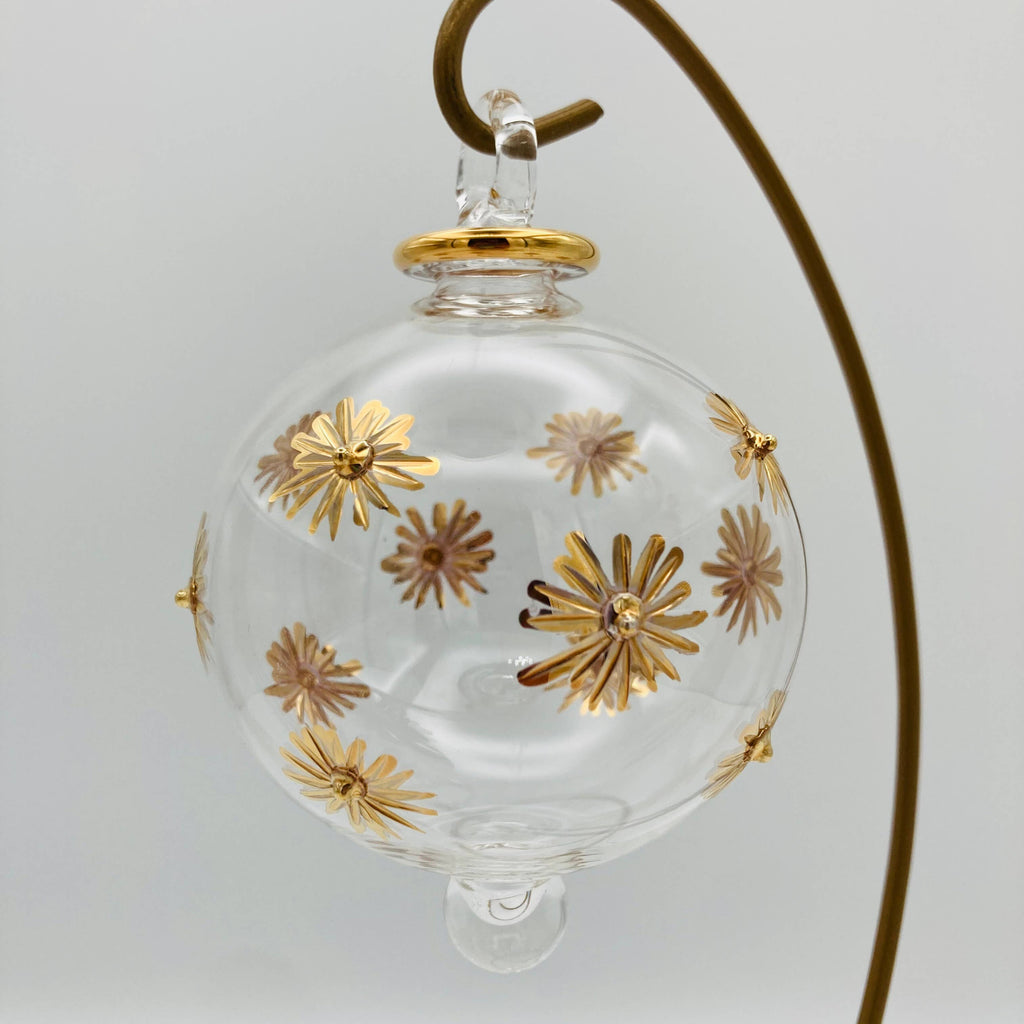 Clear glass ornament with gold floral designs 