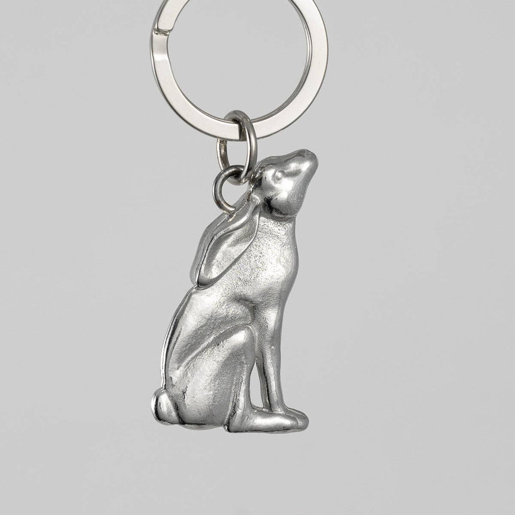 Pewter hare-shaped keychain on a gray background