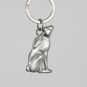 Pewter hare-shaped keychain on a gray background