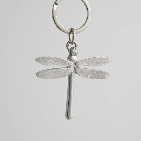 Pewter dragonfly keychain on a light gray background