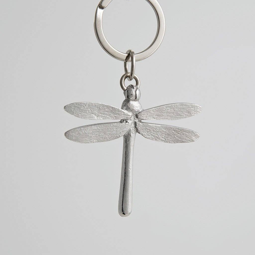 Pewter dragonfly keychain on a light gray background