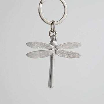 Pewter dragonfly keychain on a light gray background