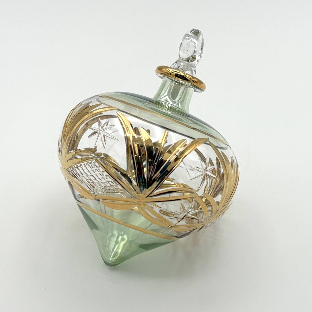Decorative drop glass ornament  in a green tone with gold accents 