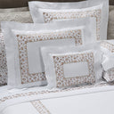Bed with floral patterned bedding and pillows in a bedroom setting.