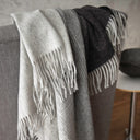 Aria throws in the colour Charcoal. The throw has a soft gradient from light grey to black with line details.