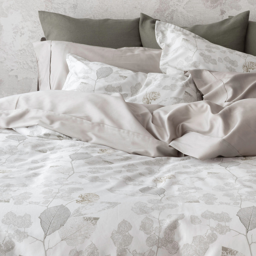 Aspen bedding display pairing with Capri Pumice pillowcases and Forma euro cushions in Juniper