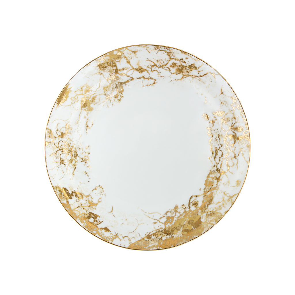Round ceramic plate with gold marbled design on a white background