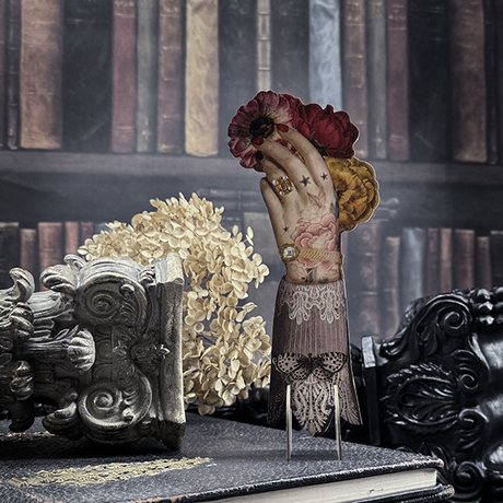 Bookmark in the shape of a hand which holds the flowers 