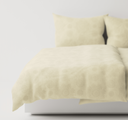 Light beige textured bedding set on a bed with a plain background