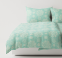 Mint green textured bedding set on a bed 
