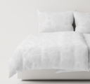 White textured  bedding set on a bed 