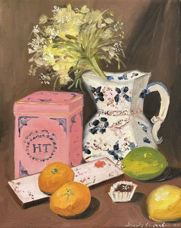 Painting of pink tea caddy, vase with yellow flower and citrus fruits and chocolate.