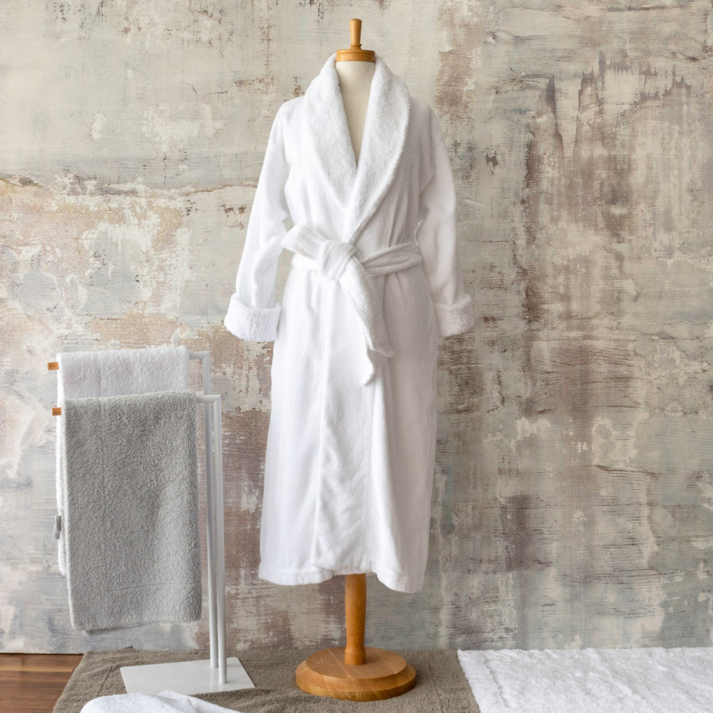 Abyss Comfy robe in white on mannequin, full length with shawl collar and tie belt.  Abyss Double bathmats hanging up and on floor.