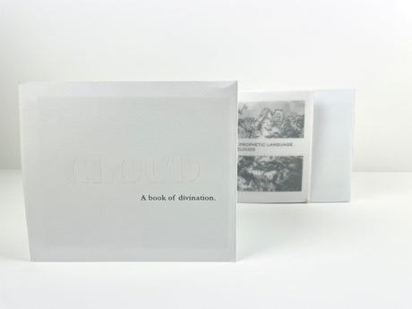 White book titled 'CLOUD A book of divination' on a white background