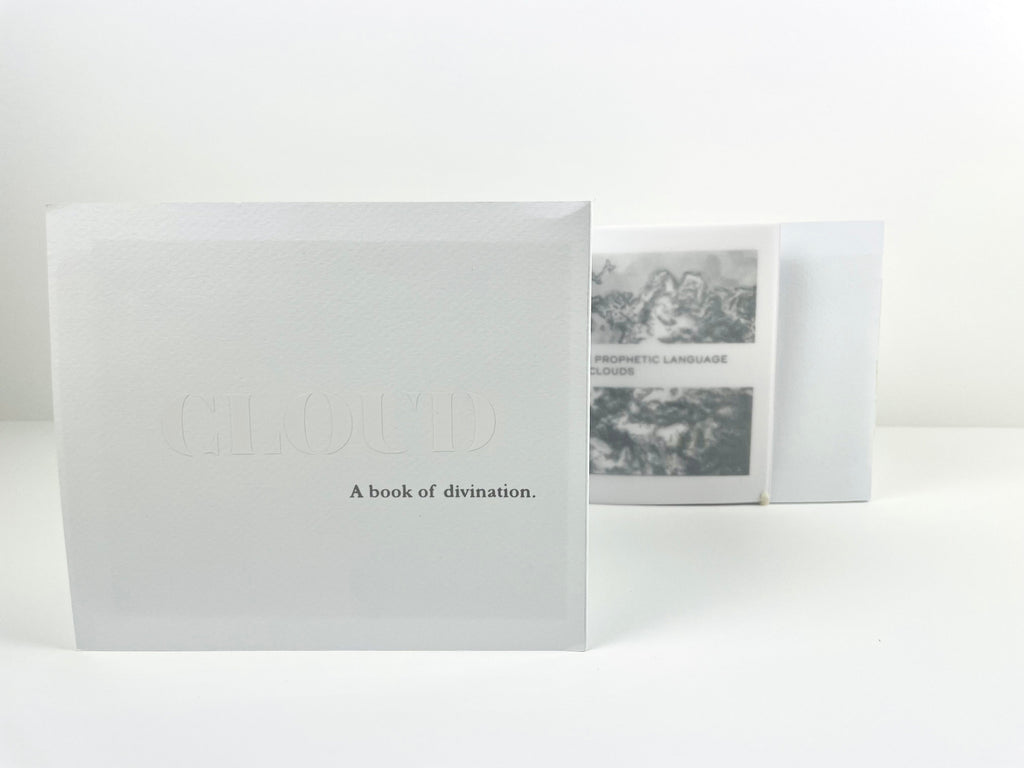 White book titled 'CLOUD A book of divination' on a white background