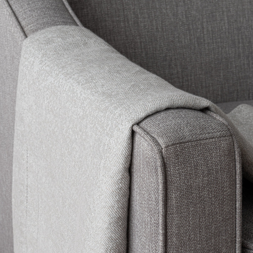 Section of Forte Grey throw draped over arm of armchair