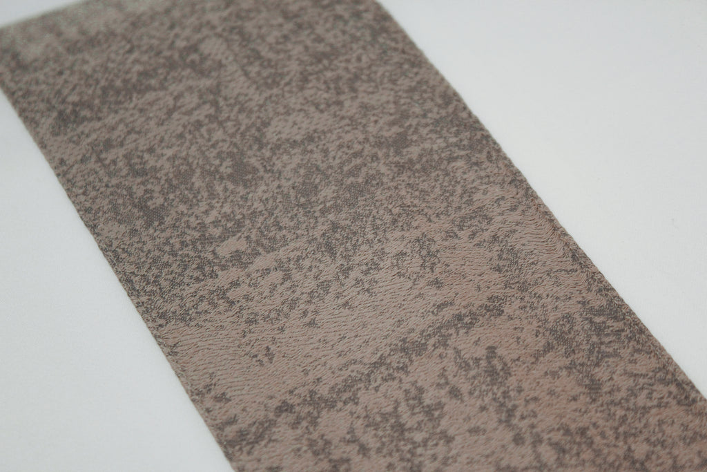 Close up of the taupe jacquard band for the pillowcases on the Ivory, cotton sheet