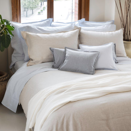 Linen bedding in sky, linen and mist colours in front of window