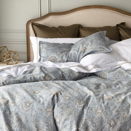 Floral bedding in light grey/blue colour set up on bed 