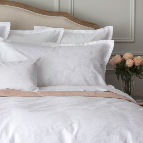Textured floral white bedding set up on the bed