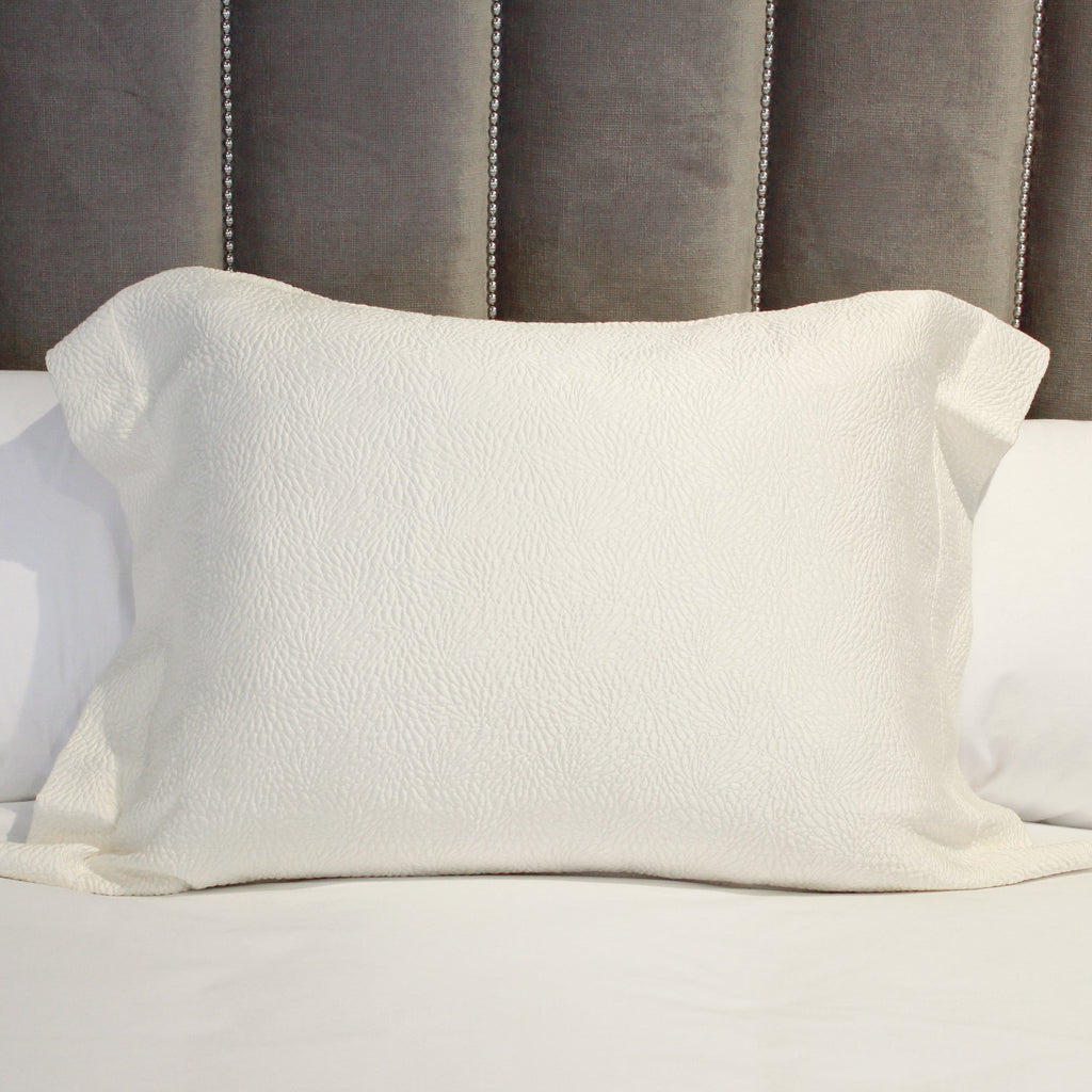 SDH Jazz Snow sham on bed against padded headboard