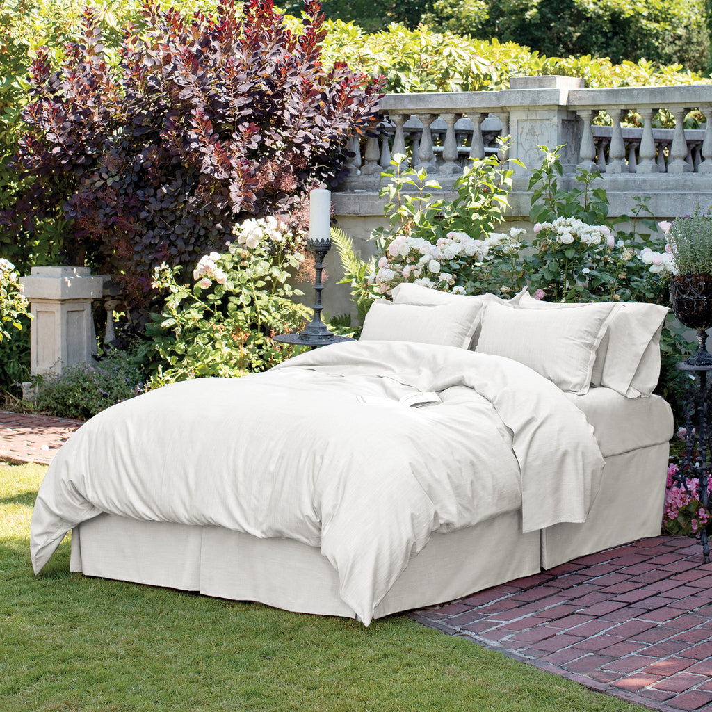 Lanoso Bedding shown on bed set in a garden