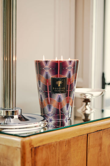 Baobab Nyeleti candle on sideboard with metal post to the left and a metal dish behind