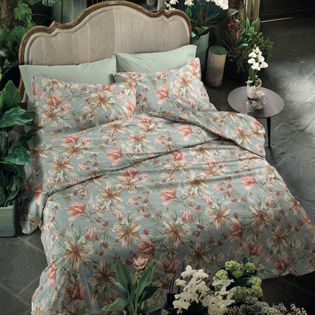 Floral bedding set on a bed in aqua and coral tones.
