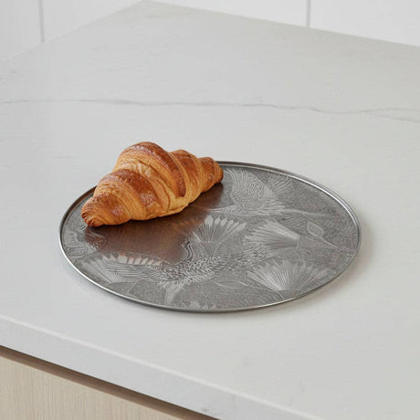 Decorative metal Tray with floral patterns on a white surface