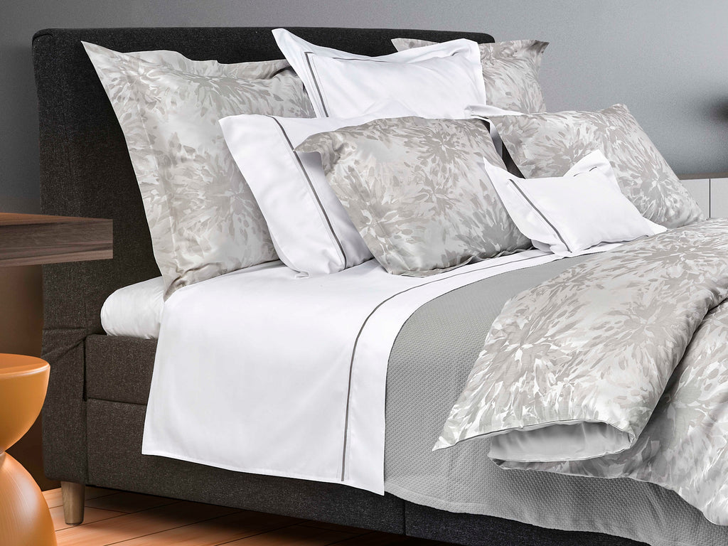 Noto Grey bedding with white sheets and grey trim
