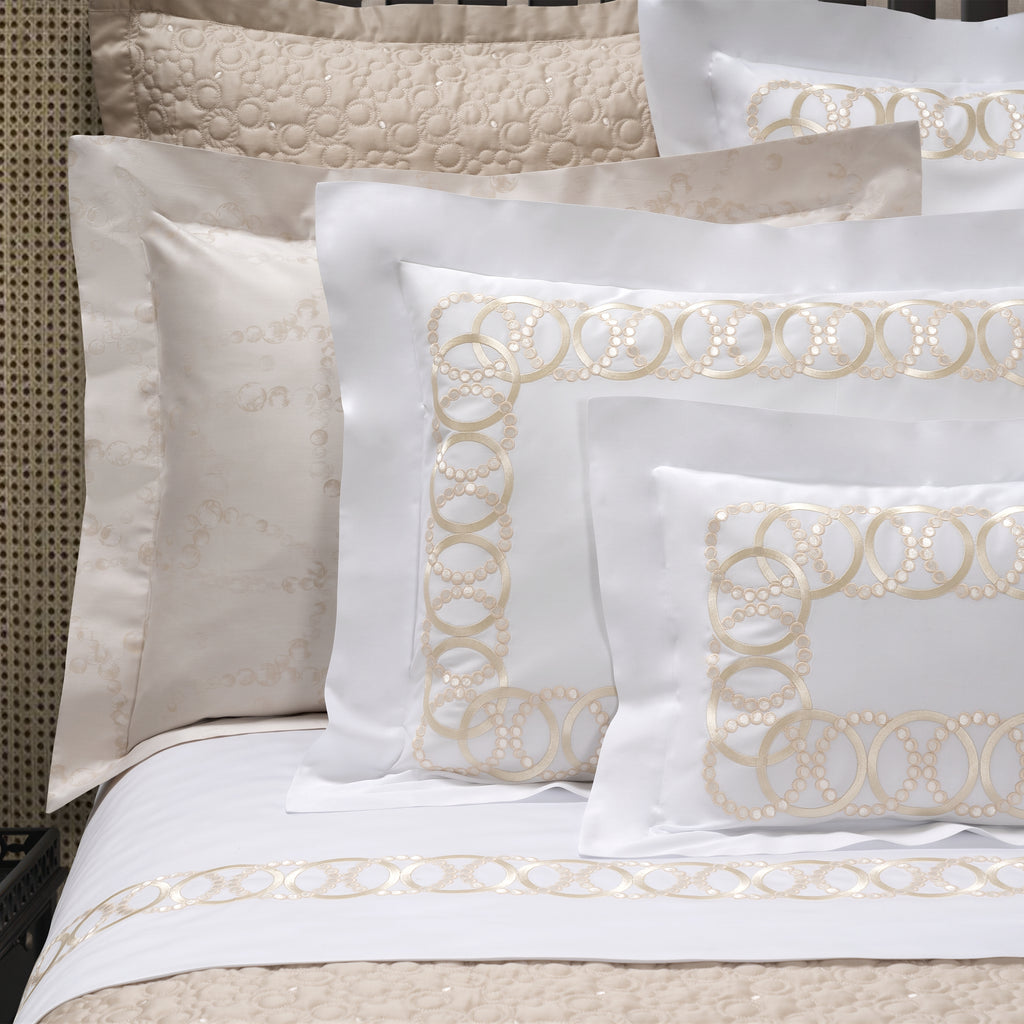 White Sham with decorative gold-tone embroidery on the bed 