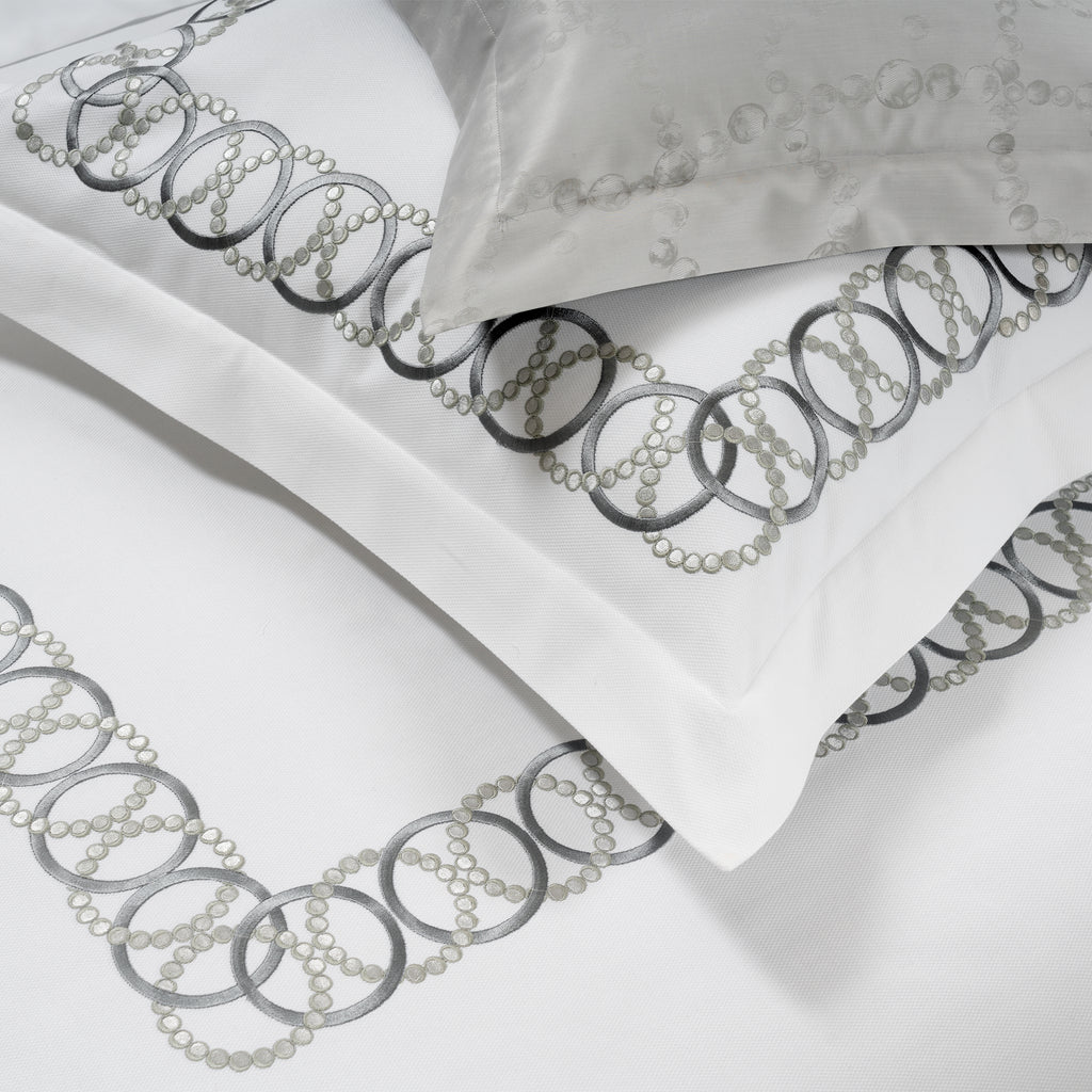 White Sham with decorative grey embroidery on a white background