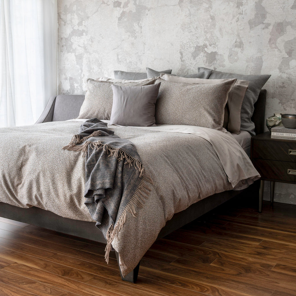 Rio Walnut bedding display with duvet cover and pillowcases. Paired with Capri Taupe pillowcases and shams. Adding in decorative elements of Zora euro shams, and Reneta throw.