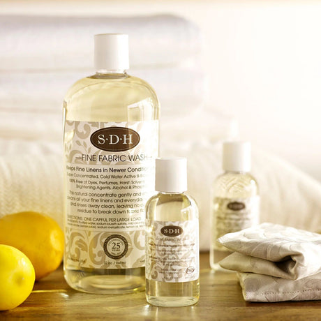 A bottle of SDH Fine Fabric Wash laundry detergent