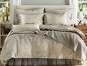 Zoya Ash duvet cover shown on bed with coordinating bedding. There are sidetables on either side with windows above them.